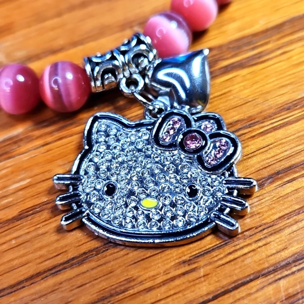 NWT Luminous "Hello Kitty" Pink Cat Eye Stretch Bracelet - Picture 2 of 3